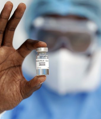 FDA Authorizes Pfizer COVID Vaccine for Youngsters 12-15 man holding coronavirus vaccine